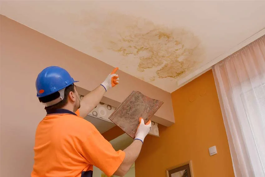 Close inspection of ceiling water stain damage performed before professional hard surface sealing service